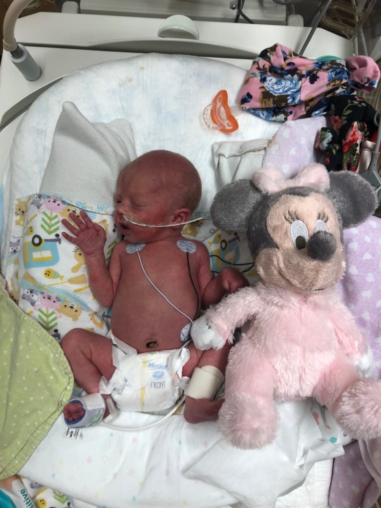 Our baby Cora while in the NICU with her Minie Mouse stuffed animal.