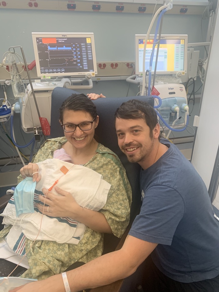 Lauren with her husband visiting her daughter in the NICU. Lauren developed HELLP Syndrome at 27 weeks. 
